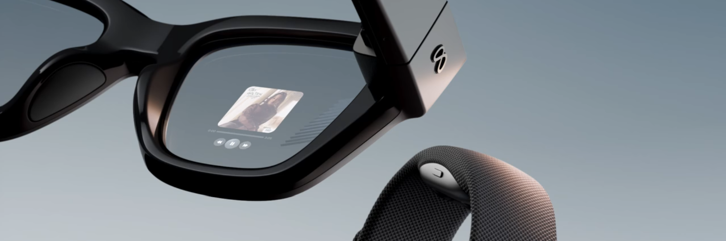Smart glasses with an active display paired with a watch band — the hardware context for the input fluency system